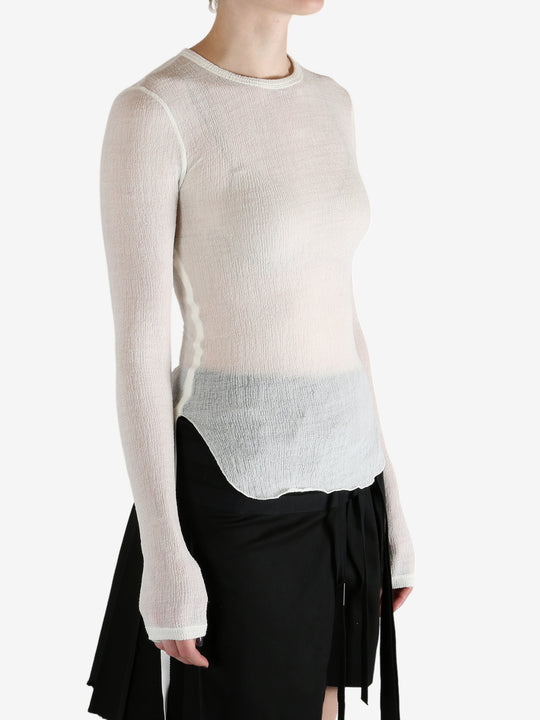 White top worn by a person, showing the top's fit