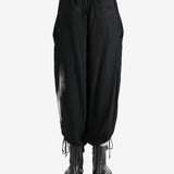 Black pants worn by a person, showing the pants fit