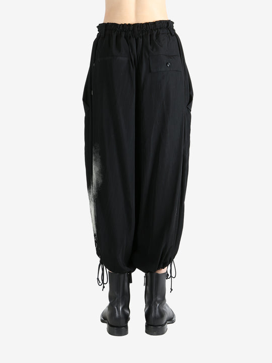 Black pants worn by a person, showing the pants fit