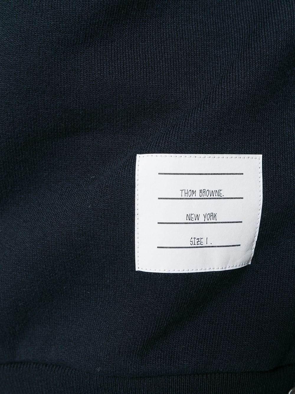 Close up of navy hoodies, showing texture of the cotton fabric