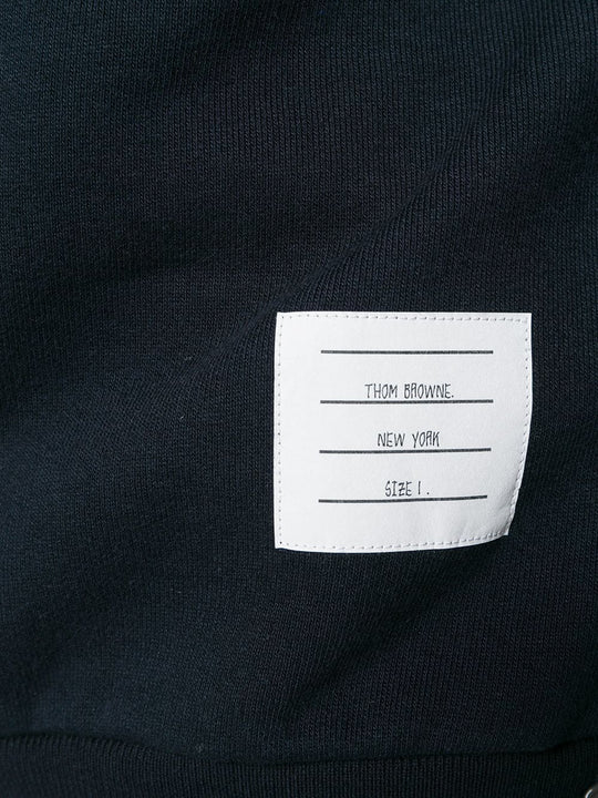Close up of navy hoodies, showing texture of the cotton fabric