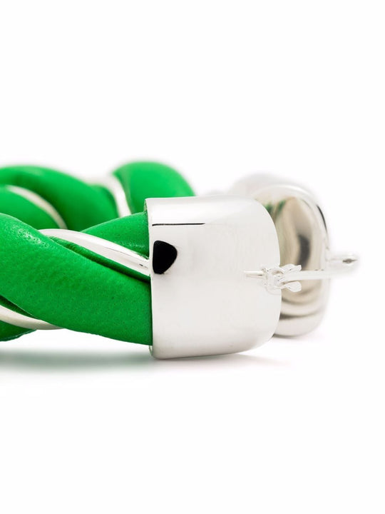 Close up of green eartrings, showing texture of the sliver fabric